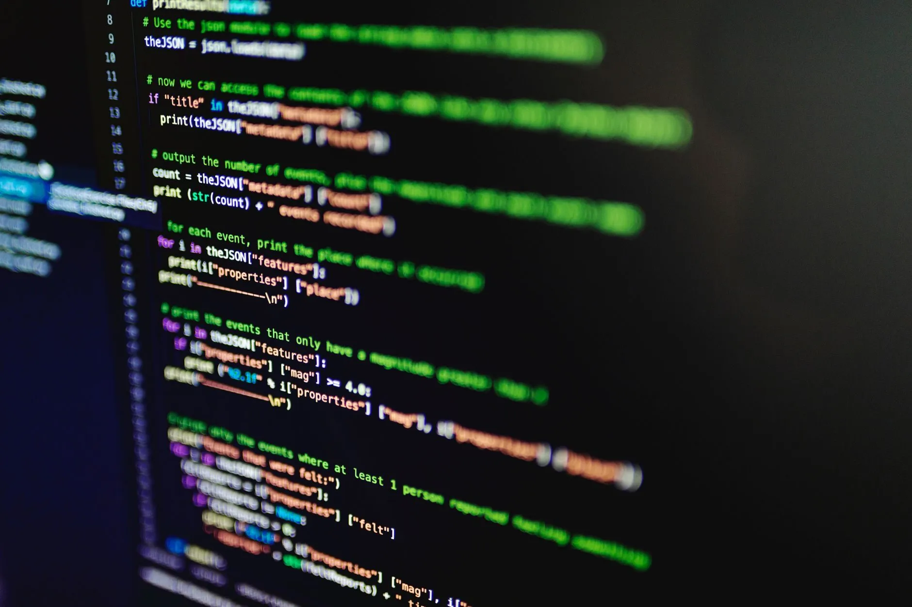 Code on a dark screen, shot at an angle with a shallow focus