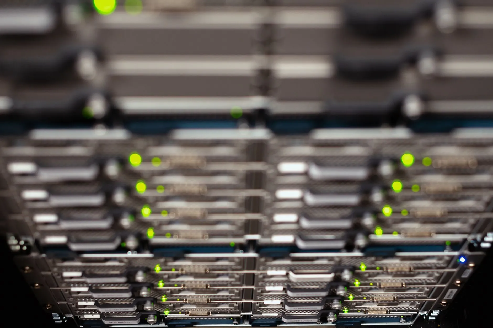 Rows of server blades with green status lights, shot from below